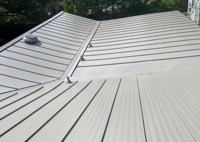 Solar attic fan installed on a metal roof for Roof Ventilation in Lake Dallas